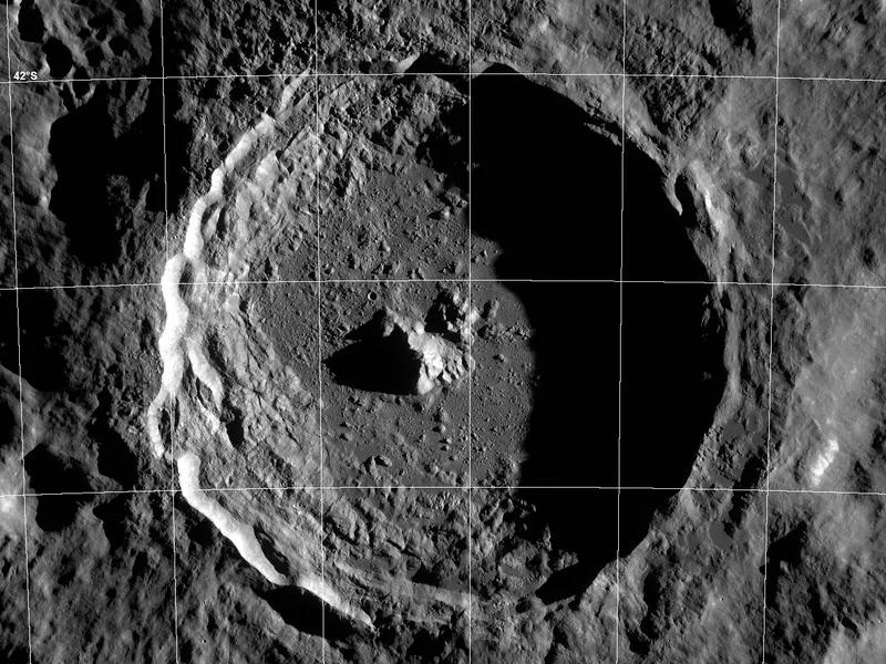 A large round crater with a central peak and bright rays of material around it